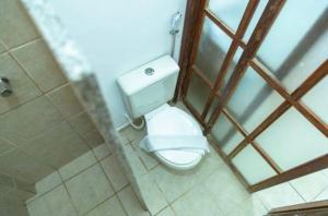 La salle de bains est pourvue d'une douche et de toilettes. dans l'établissement Apartamento Village do Bosque - a 200 metros da praia, à Porto Seguro