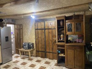 a kitchen with wooden walls and a refrigerator at Portak GuestHouse Near SEVAN Lake in Sevan