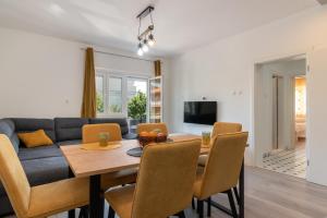 uma sala de jantar e sala de estar com mesa e cadeiras em Apartman Galeb em Trogir