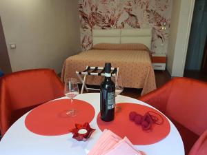 a table with a bottle of wine and two glasses at RF Duomo suites in Florence