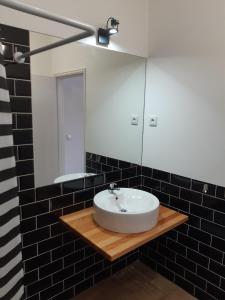 a bathroom with a white sink and a mirror at Casa do Coura in Caminha