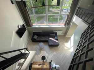 an overhead view of a living room with a large window at Old Town Loft DELUXE in Klaipėda