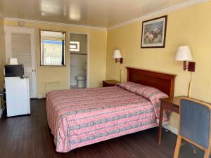 a hotel room with a bed and a bathroom at Downbeach Inn in Atlantic City