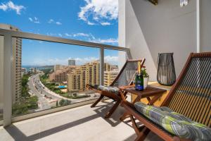 a balcony with two chairs and a table at Casa Keronen - Elite Residence in Portimão