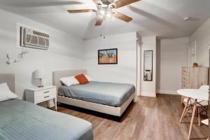 a bedroom with two beds and a ceiling fan at Brooklyn Beach Club in Wildwood
