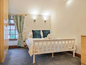 a bedroom with a white bed and a window at Agniti Cottage in Derby