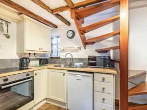 a kitchen with a sink and a microwave at Agniti Cottage in Derby