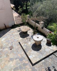 a stone patio with two benches on top of it at Dionysus Apartments & Studios in Syvota