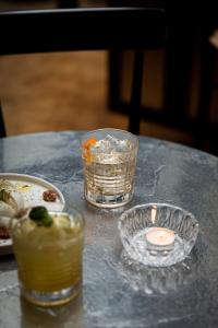 a table with a candle and plates of food at Hôtel Wallace - Orso Hotels in Paris