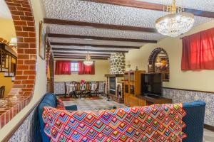 a living room with a couch and a tv at Sun&Beach Retreat in Ponta Delgada