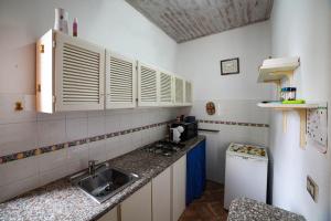 a kitchen with a sink and a counter top at Il Quattro in Alghero