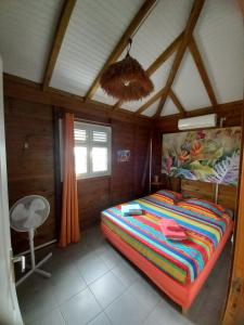 a bedroom with a large bed in a room at Kaz Touloulou in Saint-François