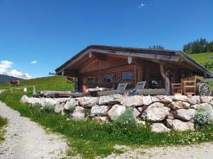 a log cabin with a stone wall in front of it at Sauschneidhof - Radstadt in Radstadt