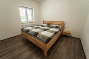 a bedroom with a bed in a room with a window at apartmán Sedmička Frymburk in Frymburk +19 photos