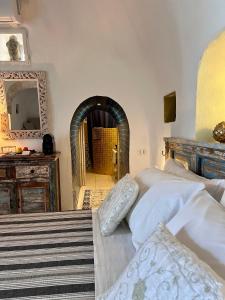 a bedroom with a bed and a mirror at Il Saraceno B&B in Carovigno