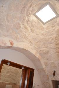 a skylight in a room with a stone ceiling at Dimora Domrose in Locorotondo