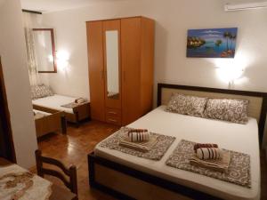 a small bedroom with a bed and a cabinet at Apartments Aleksic in Sutomore