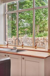 a kitchen with a sink and a window at Plum Cottage in Appleby