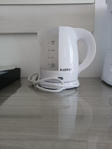 a white coffee pot sitting on top of a counter at Golden Sand in Marathokampos