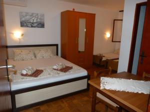 a bedroom with a bed and a table in a room at Apartments Aleksic in Sutomore