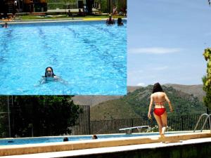 a woman in a swimming pool with people in the water at Casa Rural Ca Lluis in La Vall de Laguar