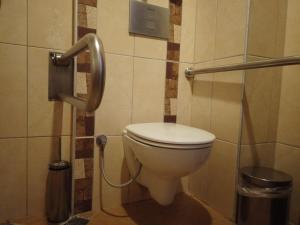 a bathroom with a white toilet in a stall at Oba Time Hotel in Alanya