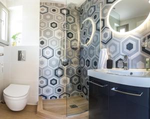 a bathroom with a toilet and a sink and a shower at GAIA MAISONETTES in Nea Kalikratia +76 photos