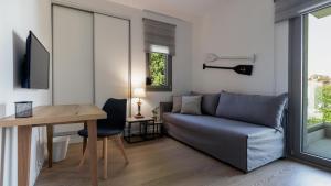 a living room with a couch and a table at GAIA MAISONETTES in Nea Kallikrateia