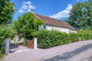 a white house with a gate and a fence at Crazy Villa Margotterie 58 - Heated pool - 2h from Paris - 30p in La Celle-sur-Loire
