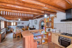 Il comprend une cuisine dotée de plafonds en bois et une salle à manger. dans l'établissement La Vinya Pineda de Mar, à Pineda de Mar