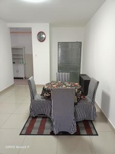 two chairs and a table in a room at JANNAH HOMESTAY in Putrajaya