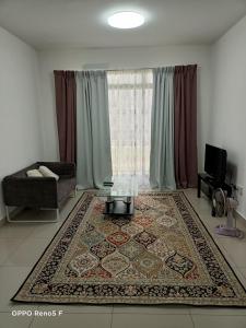 a living room with a large window and a rug at JANNAH HOMESTAY in Putrajaya