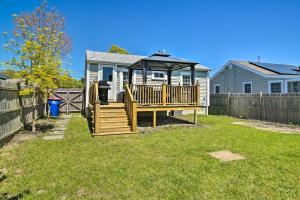 a backyard with a wooden deck and a gazebo at Wareham Cottage with Deck, Walk to Swifts Beach in Wareham