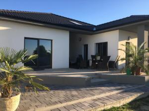 a house with a patio and a dining room at Apartmány Dimitra 2 in Štúrovo