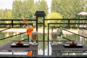 a table with two plates of food and glasses on it at Near the Lake in Lviv