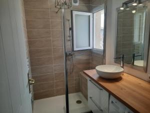 a bathroom with a sink and a glass shower at Coeur Marina climatisé terrasse parking in Fréjus