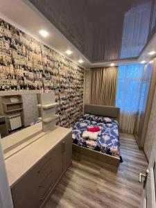a bedroom with a bed and a brick wall at Apartament DeLux Sea View in Batumi