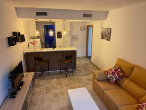 a living room with a couch and a kitchen at Apartamento El Azul in Molina de Segura