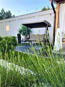 a patio with a bench and a picnic table at Casa 1A in Eforie Sud +63 photos