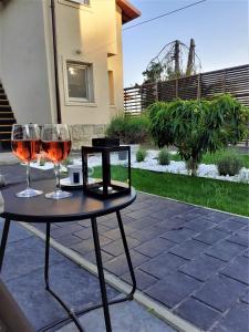 two glasses of wine sitting on a table at Casa 1A in Eforie Sud