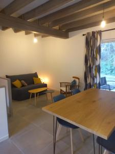 a living room with a table and a couch at Les Eygletières in Bourriot-Bergonce +27 photos