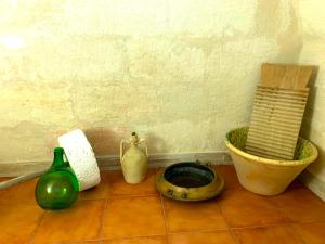 a group of vases sitting on a tile floor at Al Vicoletto in Ginosa