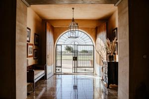 a hallway with an entry way with a large glass door at Finca Gomera - Agroturismo Hotel in Cala Pi