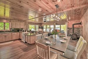 a kitchen with a table and chairs in a room at Lakefront Gloversville Home with Beach and Dock! in Broadalbin