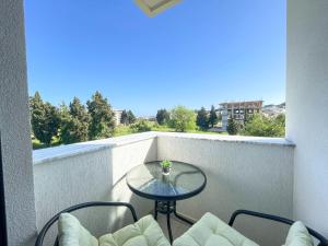 a balcony with a table and chairs on a balcony at MaNora in Ulcinj