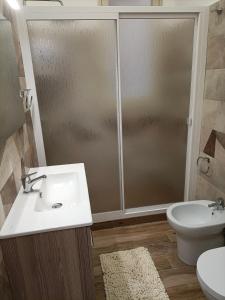 a bathroom with a shower and a sink and a toilet at TINTARELLA in Trapani