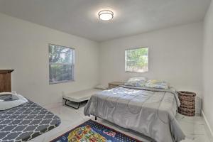 a bedroom with a bed and a couch and two windows at Pet-Friendly Miami House about 8 Mi to Beaches! in Miami