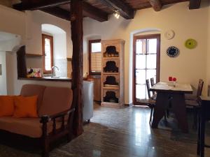 a living room with a couch and a table at La Baita di Francesca in Rido +16 photos