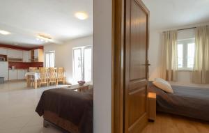 a bedroom and a living room with a bed and a kitchen at Apartments Valeria in Korčula +31 photos