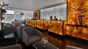 a bar in a restaurant with chairs and a wall at Hotel Unique Pearl in Dortmund